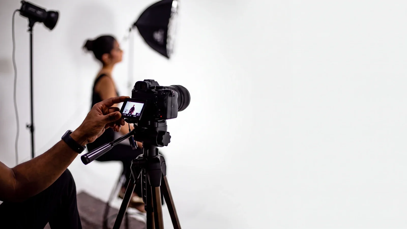 Videographer checking the camera during a studio interview shoot